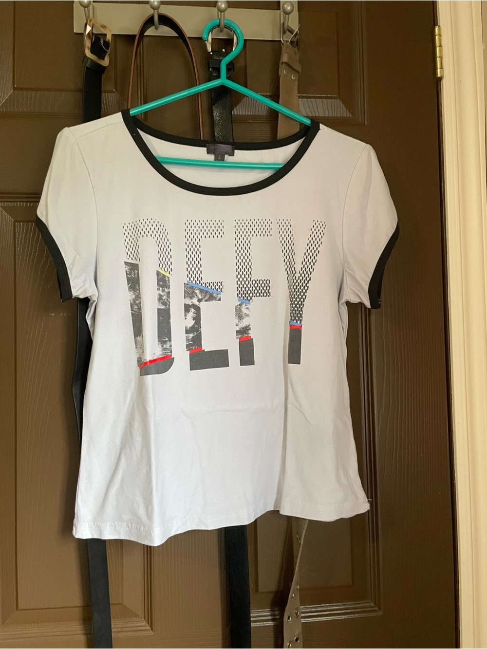 Ardene White Short Sleeve Tee with Black Trim and DEFY Graphic